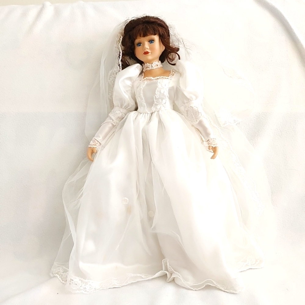 Vintage porcelain doll in wedding gown and veil. Approximately 17".
